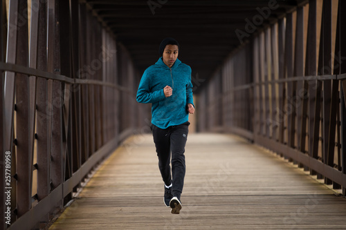 Hispanic Teenager Running By Himself On On A Bridge