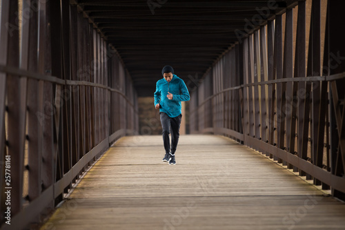 Hispanic Teenager Running By Himself On On A Bridge