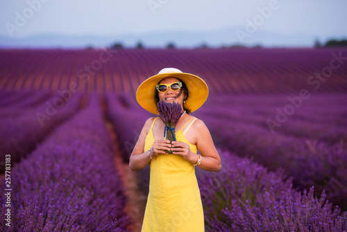 Fototapeta Naklejka Na Ścianę i Meble -  asian woman in yellow dress and hat at lavender field