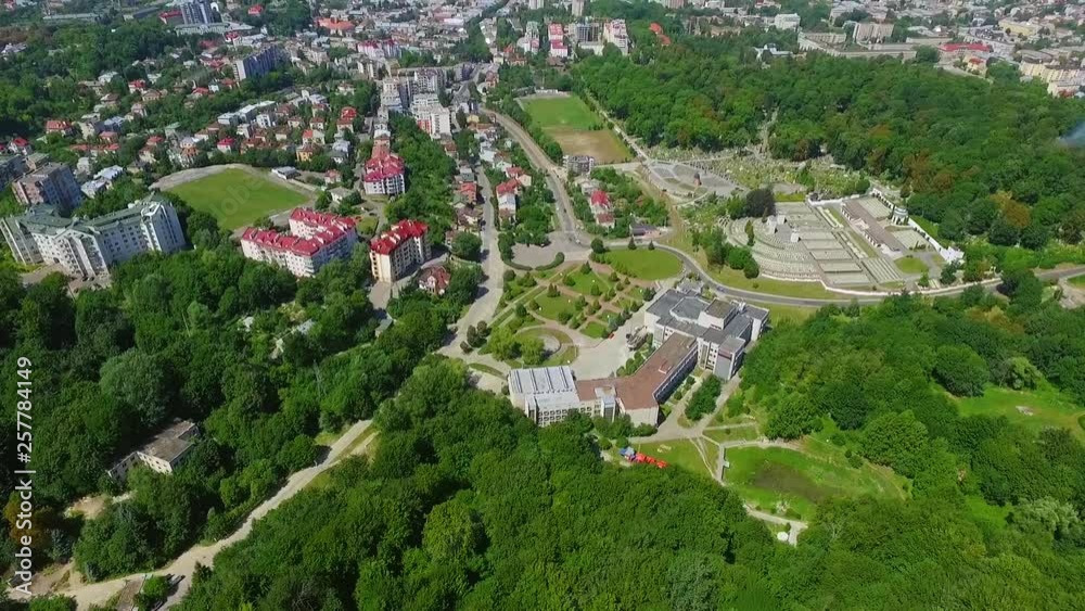 Extremely beautiful drone flight aerial view of the city, quarters, apartment buildings, cemetery. Architecture, cityscape, landscape design