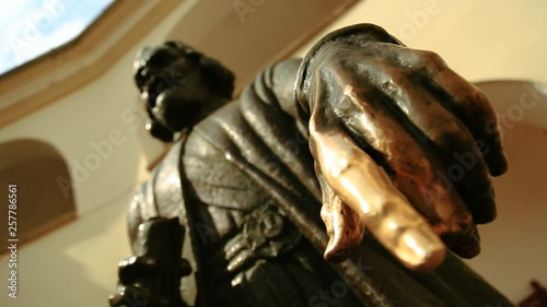 Close up view of male monument of the ruler with shabby forefinger. For luck, fortune, happiness. Castle, museum, exploring the history. Enjoying the legend, having fun photo