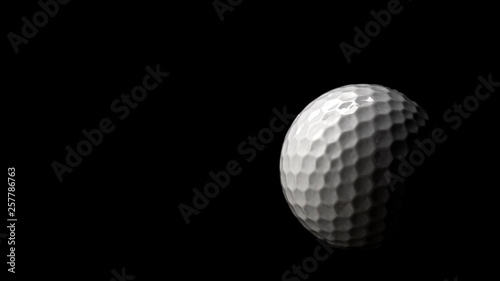 High contrast studio shot of golf ball isolated on black background with dramatic light and copy space