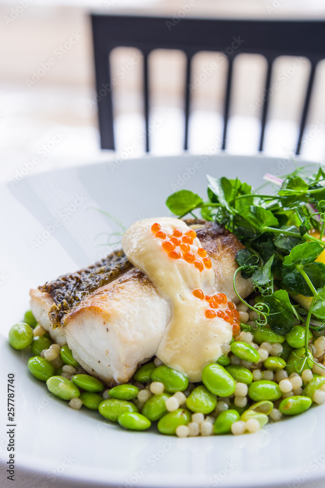Grilled Trout with roe, pea shoots, edamame and sauce Grilled Trout with roe, pea shoots, edamame and sauce