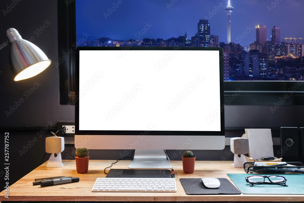 Graphic designer's workspace with a pen tablet, a computer and white backgroud for text with beautiful view of Cityscape in Macau from Window