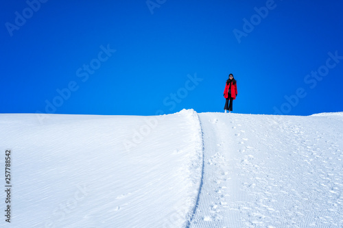 Young Woman Tourist walking in snow mountain Matterhorn peak, Zermatt, Switzerland.