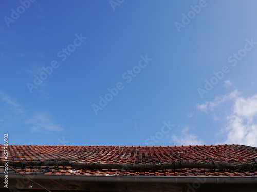 青空と古びた赤い屋根
