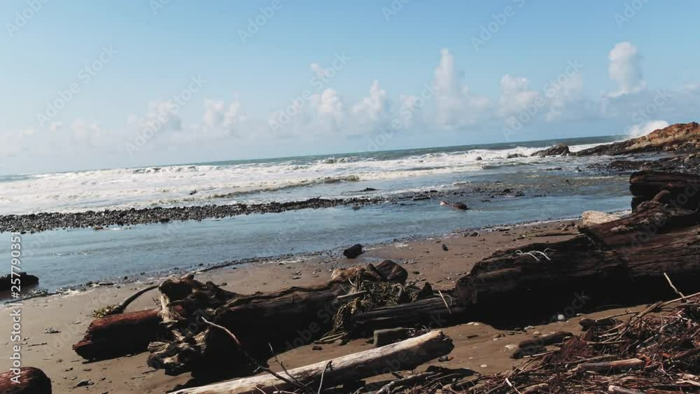 Sun drenched rocks are rhythmically beaten by Pacific Ocean Waves. Cliffs and rugged trees frame the seashore. Drone based aerial videography. Cinematic and beautiful. calming Relaxed Camping Sun drenched rocks are rhythmically beaten by Pacific Ocean Waves. Cliffs and rugged trees frame the seashore. Drone based aerial videography. Cinematic and beautiful. calming Relaxed Camping