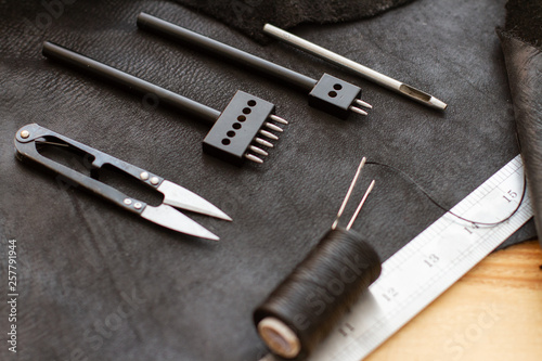 black leather and tools for leather work