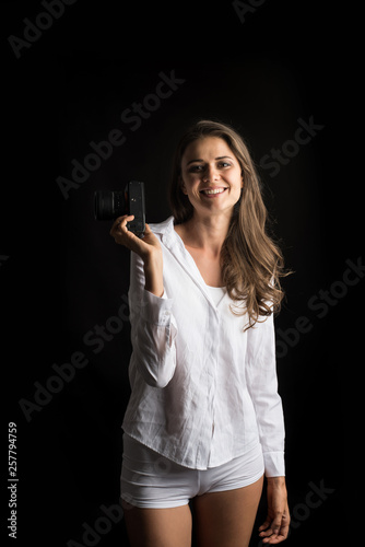 Fashion Portrait of young Woman photographer with camera © Johnstocker