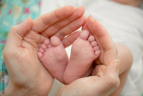 baby foot and mother hands