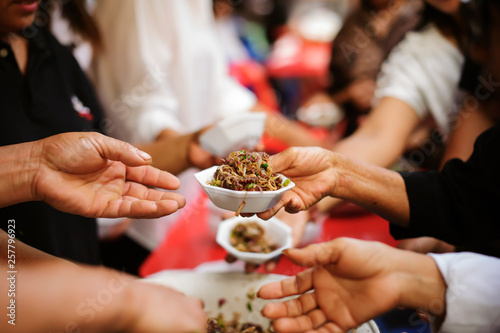 The hands of the poor donate food. Concept of famine