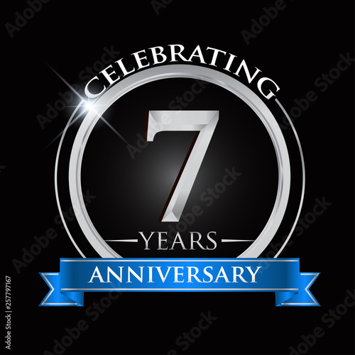 Celebrating 7 years anniversary logo. with silver ring and blue ribbon.