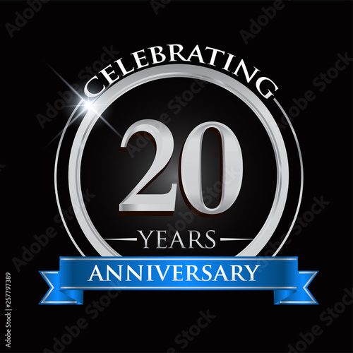 Celebrating 20 years anniversary logo. with silver ring and blue ribbon.