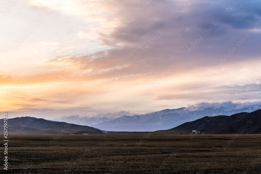 Snow Mountain Scenery of Bayinbrook Grassland in Xinjiang  ，when the sun goes down
