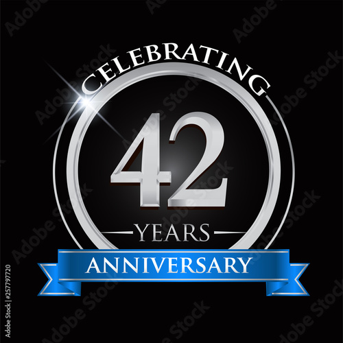 Celebrating 42 years anniversary logo. with silver ring and blue ribbon.