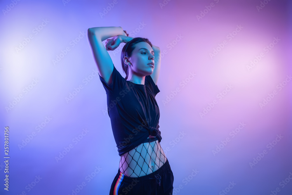 Fashion portrait of young elegant girl in jacket. Colored background, studio shot. Beautiful brunette woman posing. hipster girl in neon. Fashion portrait of young elegant girl in jacket. Colored background, studio shot. Beautiful brunette woman posing. hipster girl in neon.