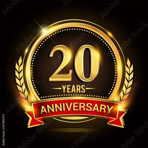 Celebrating 20th years anniversary logo with golden ring and red ribbon.