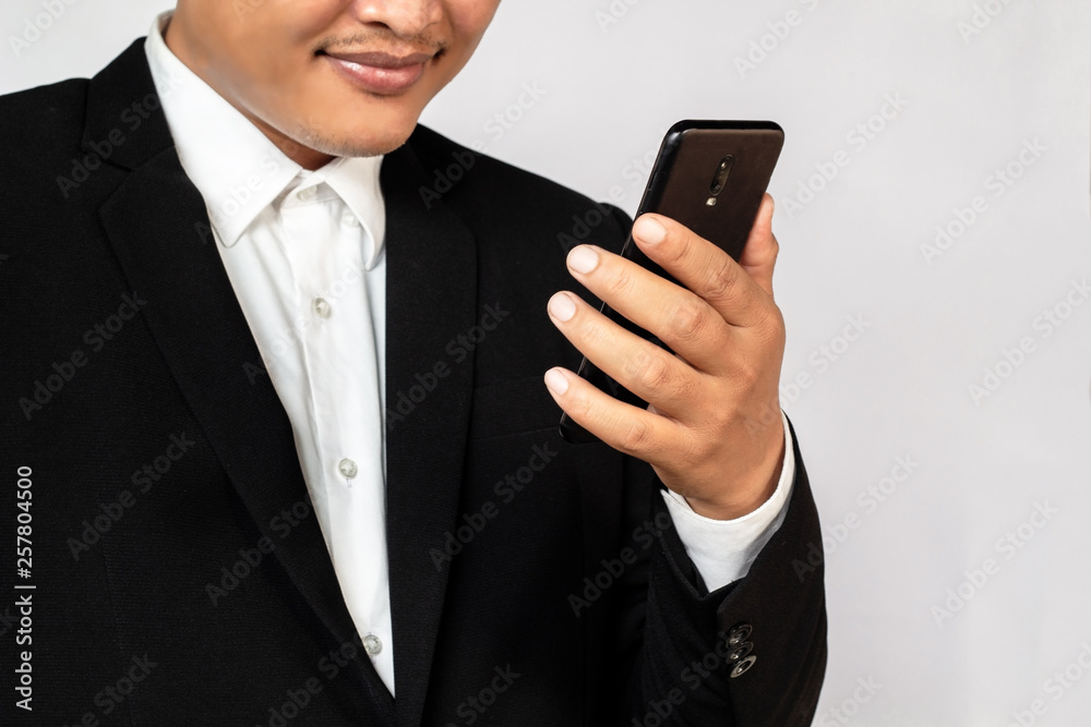 Male hand holding a smartphone on white background, business concept. Male hand holding a smartphone on white background, business concept.