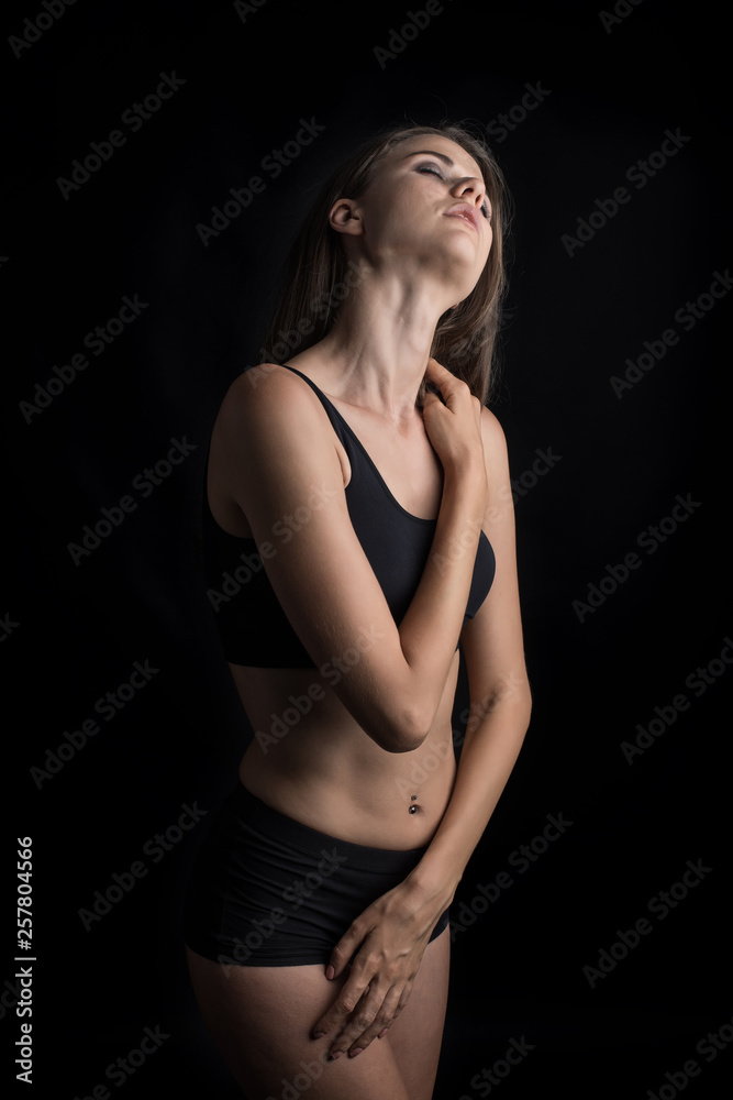 Beautiful woman with healthy body on black background Beautiful woman with healthy body on black background
