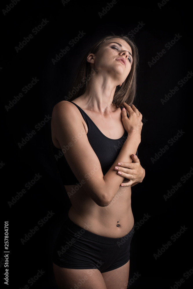 Beautiful woman with healthy body on black background Beautiful woman with healthy body on black background