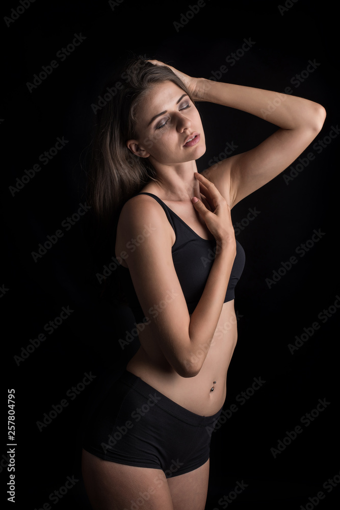 Beautiful woman with healthy body on black background Beautiful woman with healthy body on black background