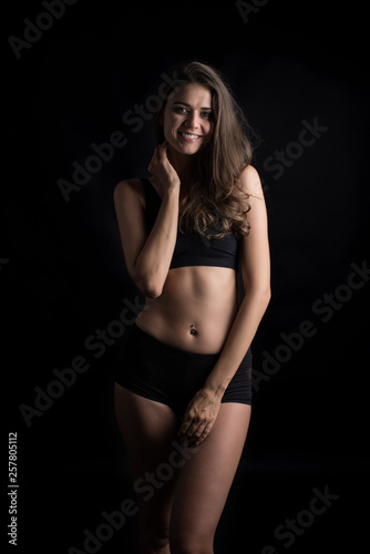 Beautiful woman with healthy body on black background © Johnstocker