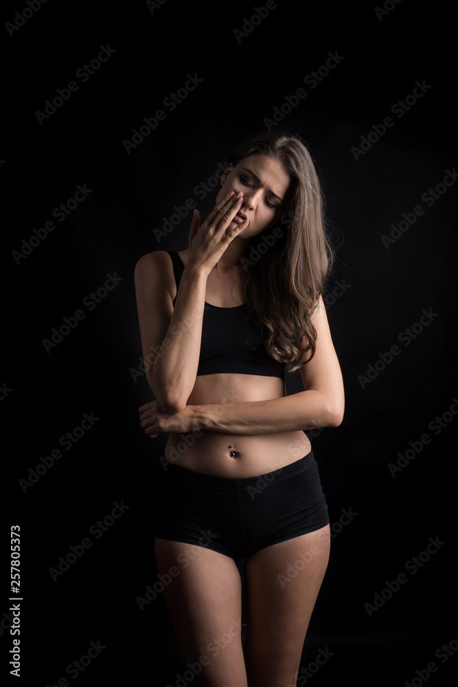 Fototapeta premium Beautiful woman with healthy body on black background