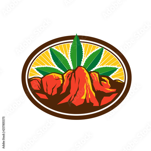Retro style illustration of a red canyon and steep cliff with hemp leaf in background set inside oval shape on isolated background.