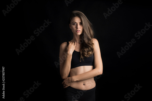 Beautiful woman with healthy body on black background © Johnstocker