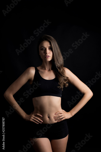 Beautiful woman with healthy body on black background