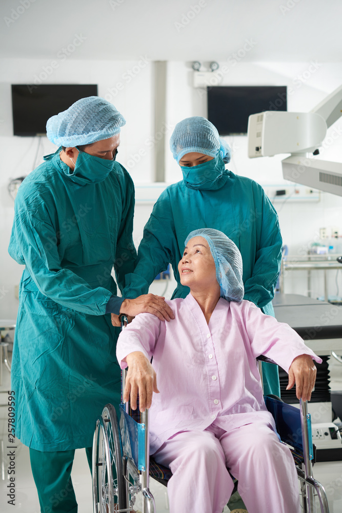 Surgeons preparing patient to operation Surgeons preparing patient to operation