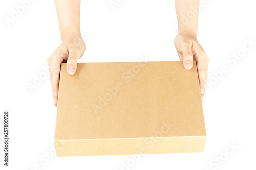 Female hand with brown parcel box isolated in clipping path. © bignai