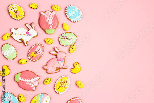 Easter homemade gingerbread cookies on a pink background with copy space.