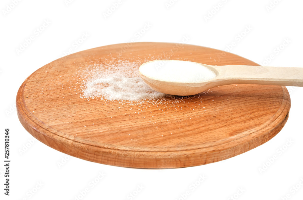 wooden spoon with sugar on a wooden board on a white background wooden spoon with sugar on a wooden board on a white background