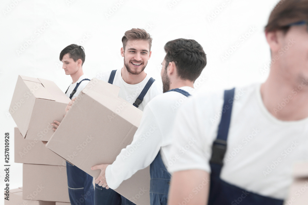 Photo workers pass each other boxes when moving flats. Photo workers pass each other boxes when moving flats.