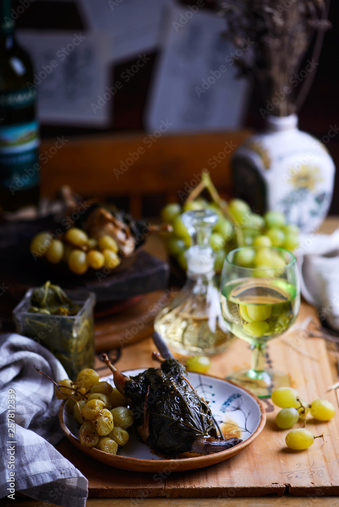 quail in grape leaves with grapes.style vintage