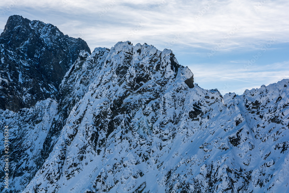 Peak and ridge in winter scenery.
