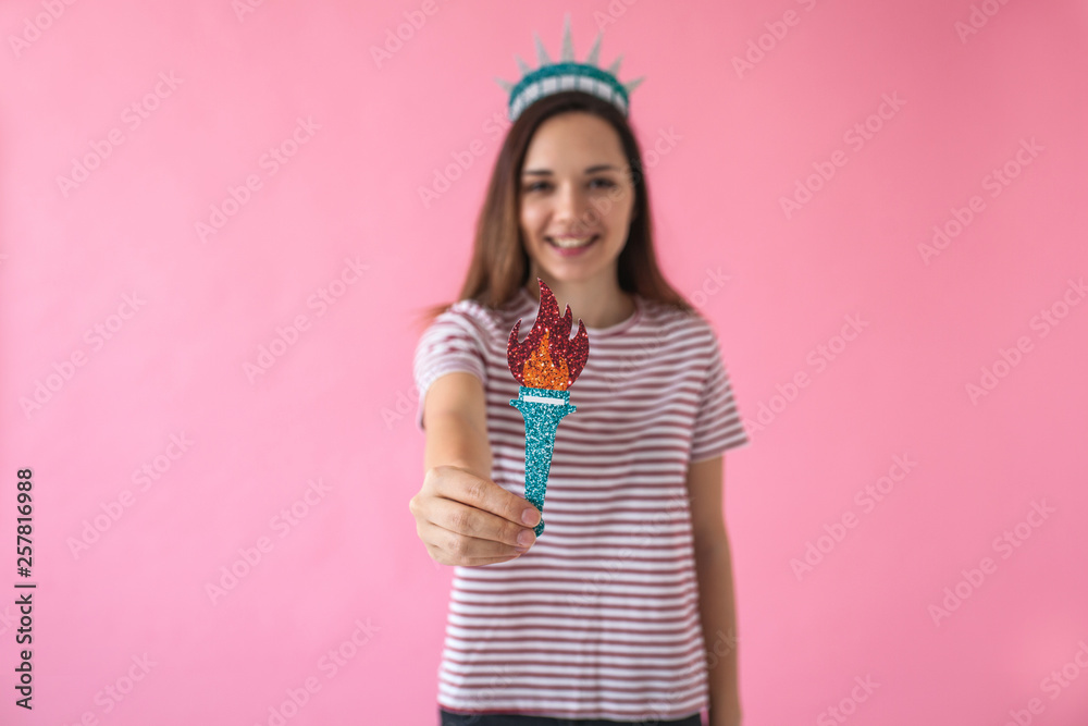 Girl as a statue of liberty - concept of learning American language or immigration or work and travel. Girl as a statue of liberty - concept of learning American language or immigration or work and travel.