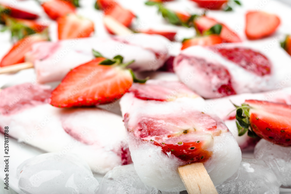 Natural juicy strawberry popsicles with yogurt or ice cream with berries.