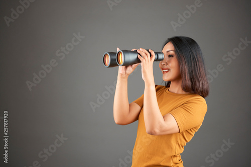 Woman observing through binoculars
