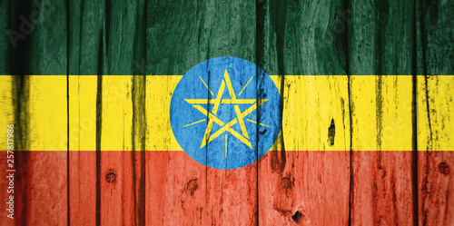 Flag of Ethiopia, background wood, dirty.