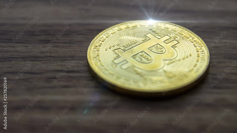 Bitcoin cryptocurrency coin on a wooden surface Bitcoin cryptocurrency coin on a wooden surface