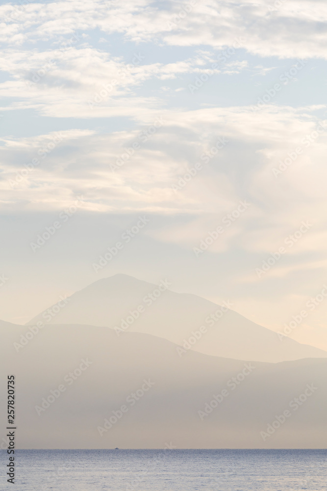 Morning view of the mountains in mainland Greece from a ferry to Meganisi island.