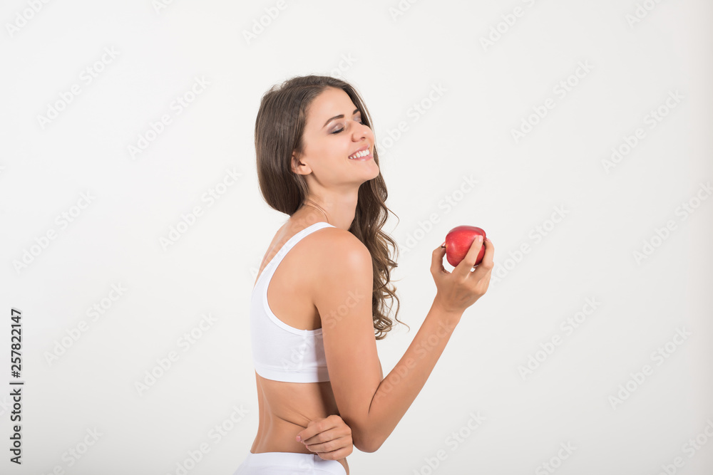 Beauty woman holding red apple while isolated on white Beauty woman holding red apple while isolated on white