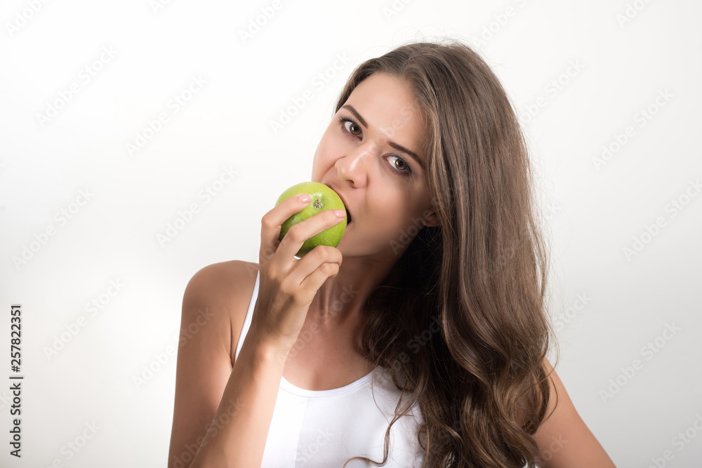 Beauty woman holding green apple while isolated on white Beauty woman holding green apple while isolated on white