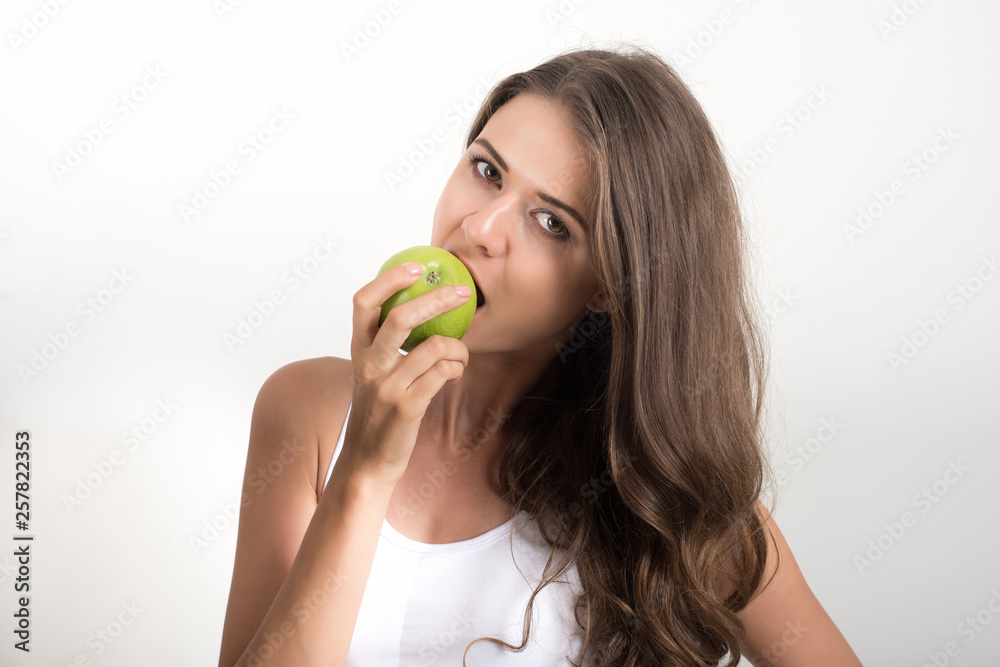Beauty woman holding green apple while isolated on white Beauty woman holding green apple while isolated on white