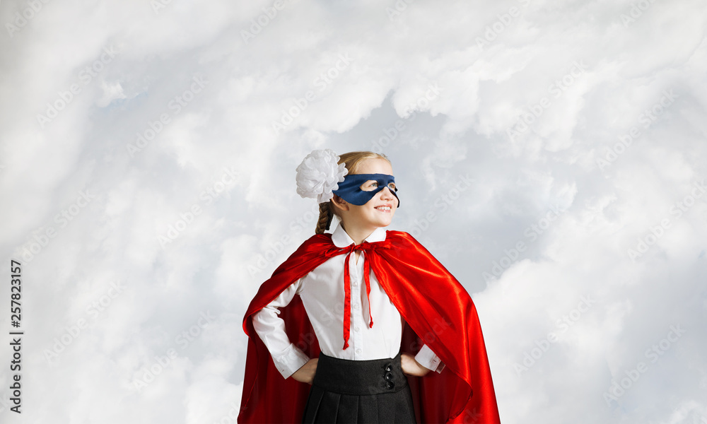 Obraz premium Girl power concept with cute kid guardian against sky background