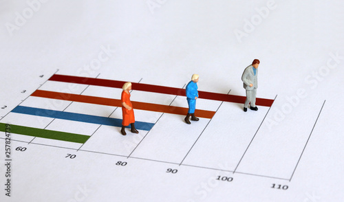Miniature old people walking on the graph. The concept of an aging society.