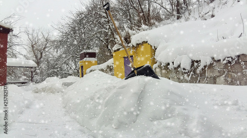 City service cleaning snow winter with shovel after snowstorm yard.