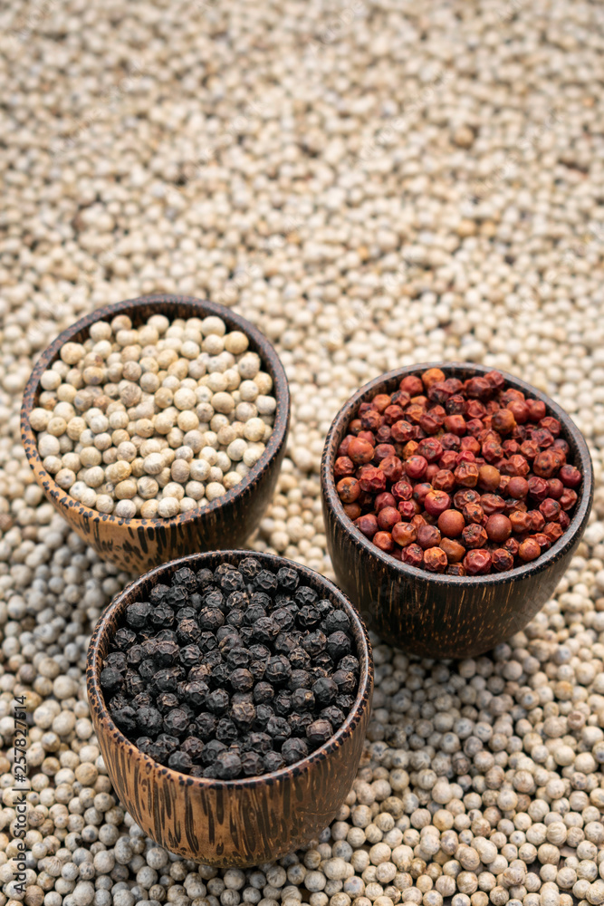 Organic white red and black pepper corns in wood display Organic white red and black pepper corns in wood display